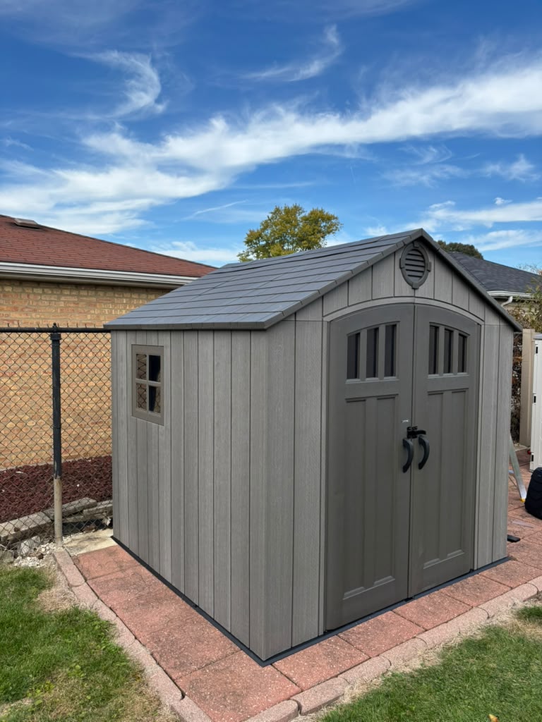 Completed gray outdoor storage shed